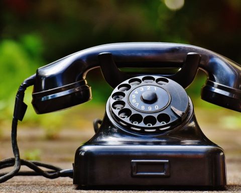 selective focus photography of black rotary phone